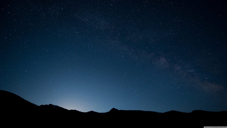 Milky Way Galaxy Arching Over Dark Mountain Silhouette at Night HD wallpaper