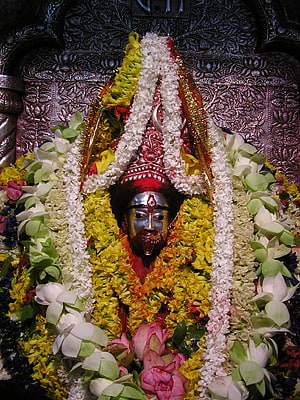 Maa Tara Divine Idol Adorned With Vibrant Flower Garlands And Ornate Temple Backdrop HD phone wallpaper