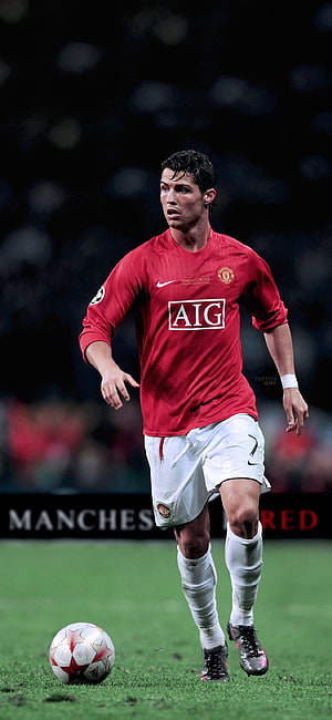 Cristiano Ronaldo in Manchester United Red Kit Dribbling Ball on Pitch HD phone wallpaper