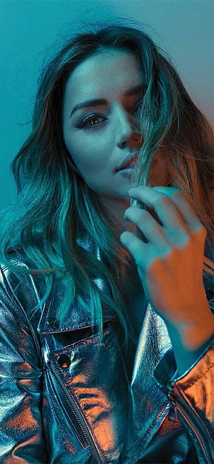 Ana De Armas in a metallic jacket with dramatic teal and orange neon lighting HD phone wallpaper