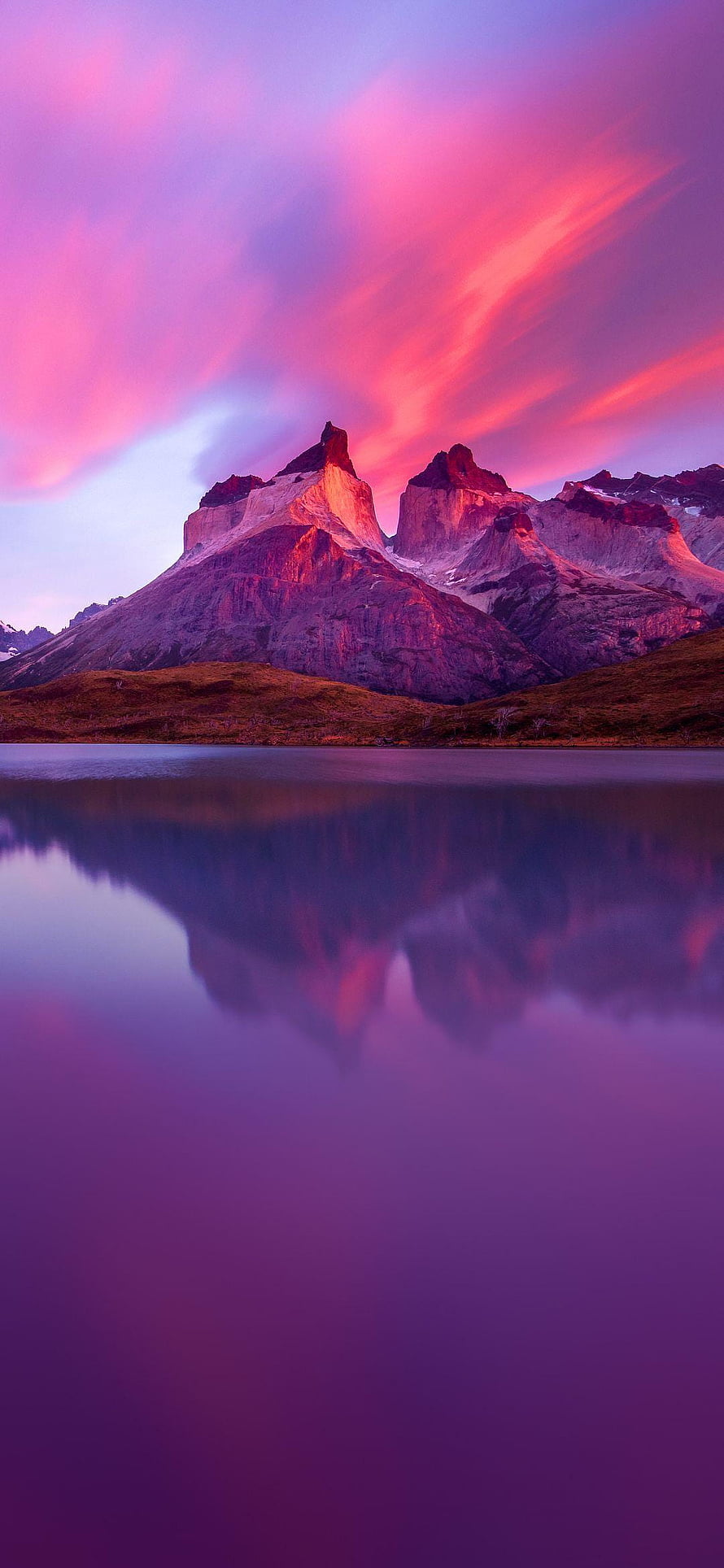 Dramatic Mountain Peaks Reflected in a Calm Lake Under a Vibrant Pink and Purple Sunset Sky HD phone wallpaper