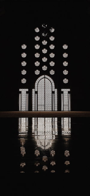 Hassan II Mosque Geometric Lattice Facade with Water Reflection at Night HD phone wallpaper
