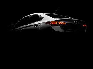 2017 Hyundai Verna Sedan Rear Three-Quarter View with Illuminated Taillights on Black Background HD wallpaper