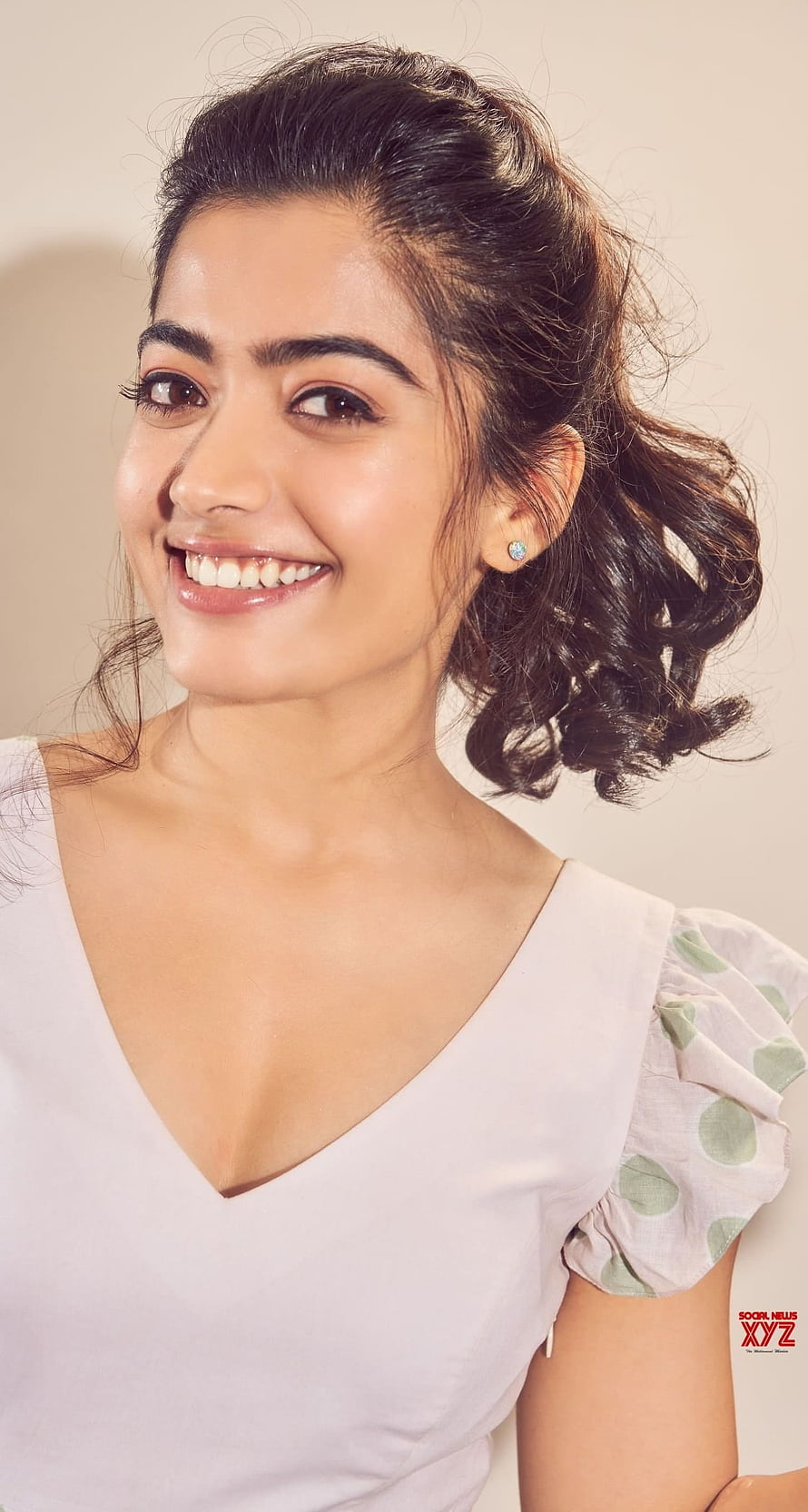 Rashmika Mandanna smiling portrait in white top with soft studio lighting HD phone wallpaper