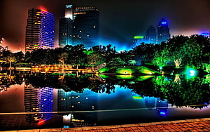 Vibrant Night Skyline of Houston Texas Reflected in Water with Colorful Skyscrapers HD wallpaper