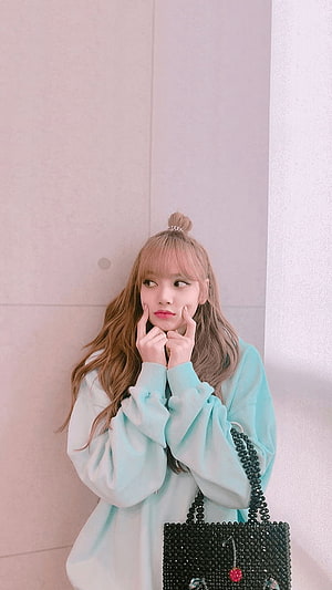 Lisa from Blackpink posing in a light blue oversized sweatshirt with a black beaded bag HD phone wallpaper