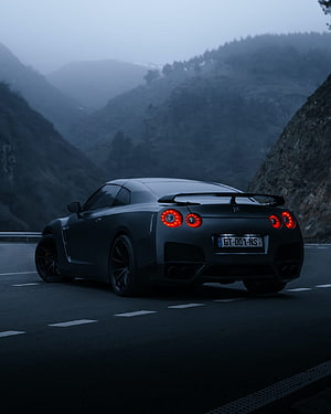 Matte Black Nissan GT-R R35 on a Misty Mountain Road at Dusk HD phone wallpaper