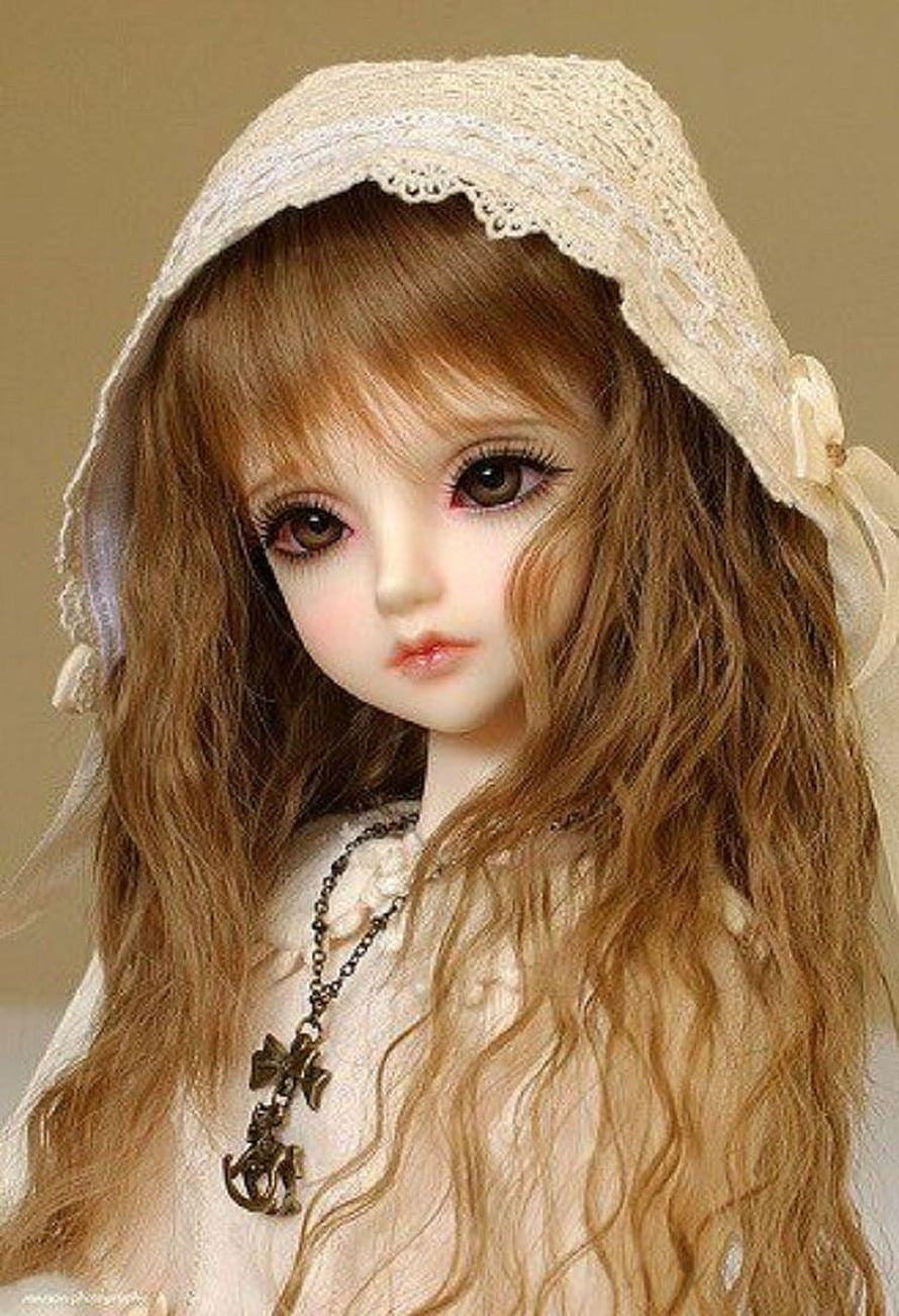 Close-up of a realistic BJD doll with long wavy hair, lace bonnet, and vintage cross necklace HD phone wallpaper