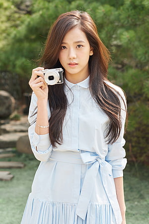 Jisoo from BLACKPINK holding a Nikon camera in a light blue dress outdoors HD phone wallpaper