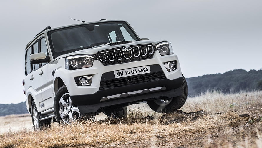 White Mahindra Scorpio S11 SUV on Dry Grassland Terrain HD wallpaper