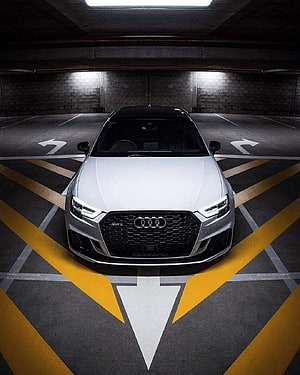 Audi RS3 Sedan Front View in Underground Parking Garage with Yellow Markings HD phone wallpaper