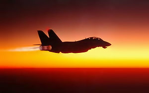 Silhouetted Fighter Jet With Afterburner Trail Against Vibrant Sunset Sky HD wallpaper