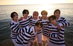 Enhypen Group Photo in Striped Jerseys at the Beach During Golden Hour HD wallpaper
