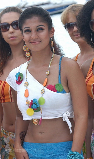 Nayanthara in colorful beachwear with floral accessories and vibrant jewelry HD phone wallpaper