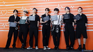 BTS Members in Black Outfits Holding Police Department Signs Against Orange Heartbeat Wall HD wallpaper