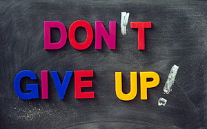 Colorful Magnetic Letters Spelling Don't Give Up on a Black Chalkboard Background HD wallpaper