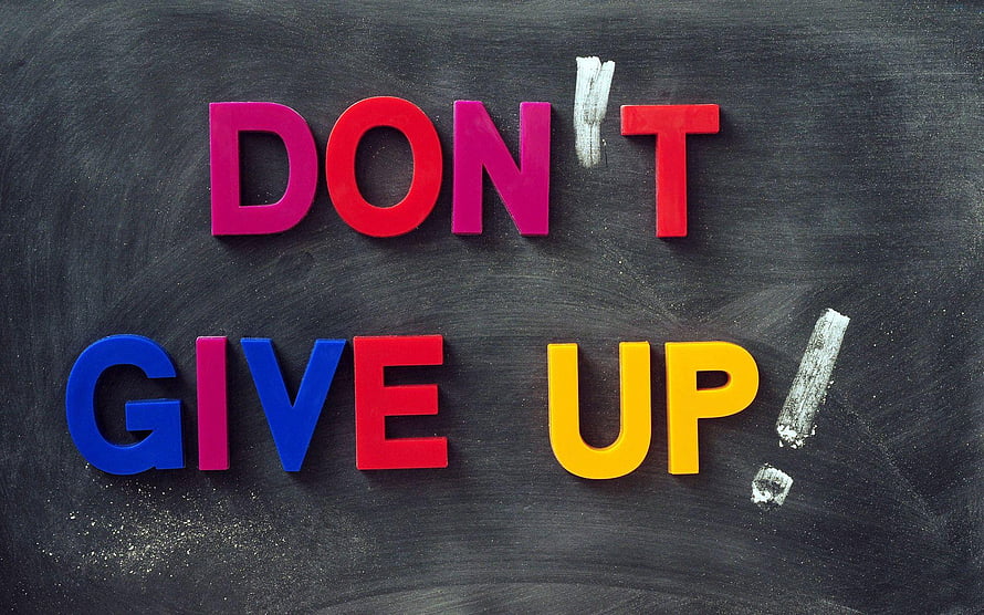 Colorful Magnetic Letters Spelling Don't Give Up on a Black Chalkboard Background HD wallpaper