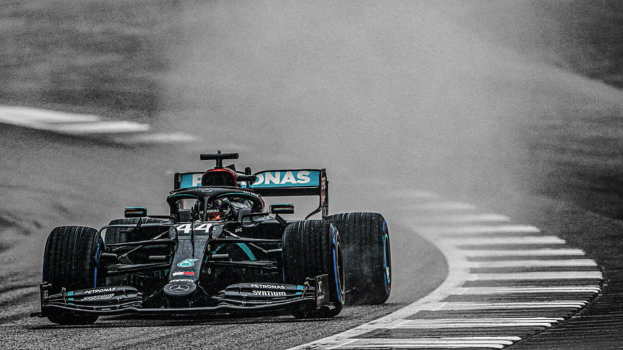 Mercedes F1 Car Racing Through Rain on Wet Track HD wallpaper