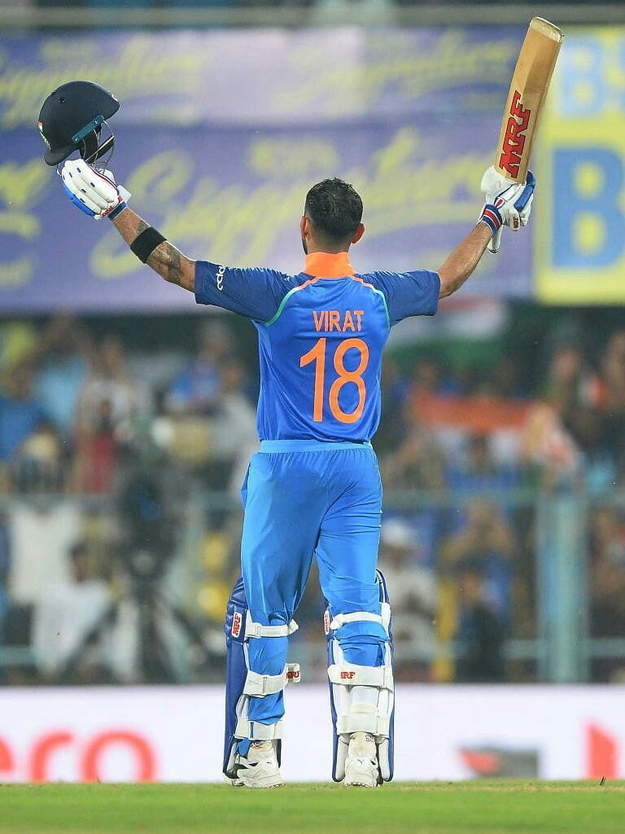 Virat Kohli in Indian Cricket Jersey Acknowledging the Crowd with Bat and Helmet Raised HD phone wallpaper