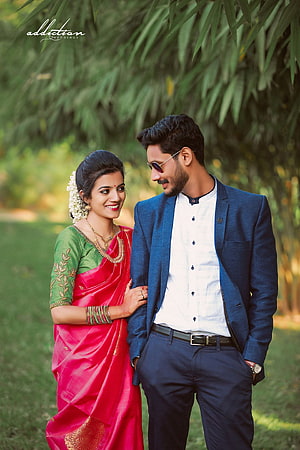 Indian Couple in Traditional Attire Standing in a Lush Green Garden HD phone wallpaper