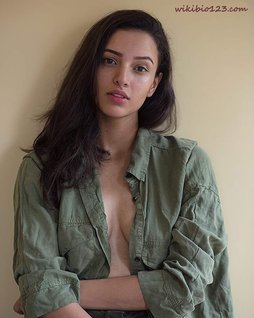 Portrait of a woman with long dark hair wearing an unbuttoned olive green shirt, Tripti Dimri wiki Bio Age Figure size Height HD phone wallpaper