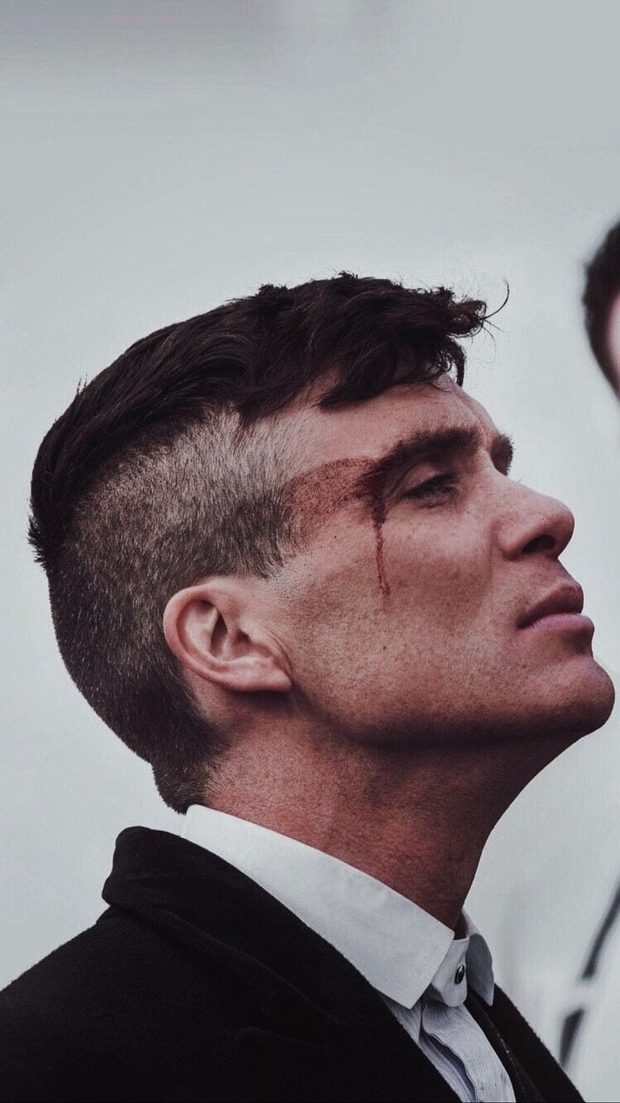 Tommy Shelby from Peaky Blinders with blood on forehead looking up in profile HD phone wallpaper