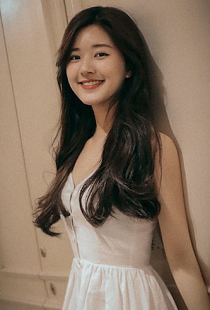 Zhao Lusi in a White Dress with Long Wavy Hair and a Warm Smile HD phone wallpaper