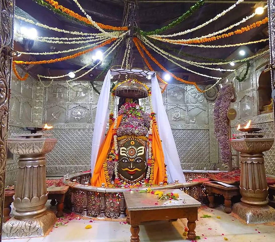 Sacred Jyotirlinga Temple Interior with Flower Garlands and Oil Lamps HD wallpaper