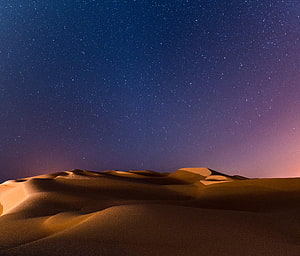 Arabian Desert Sand Dunes Under a Starry Night Sky with Twilight Horizon HD wallpaper