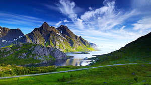 Norwegian Fjord Landscape with Green Mountains and Coastal Road HD wallpaper