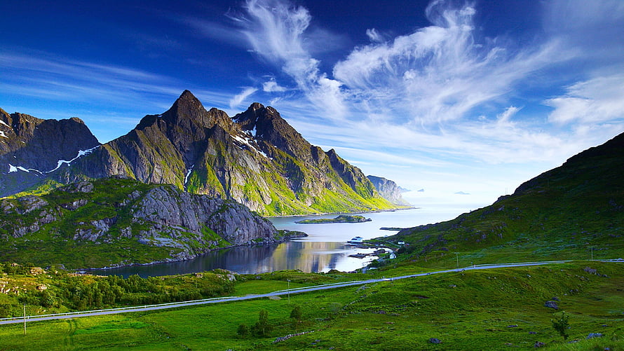 Norwegian Fjord Landscape with Green Mountains and Coastal Road HD wallpaper