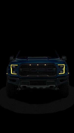 Ford F-150 Raptor Front Grille with Yellow LED Headlights in Dark Studio Setting HD phone wallpaper