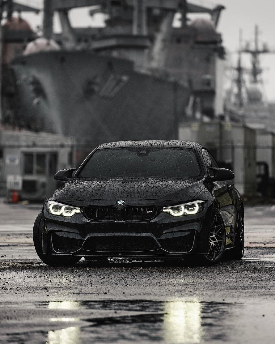 Black BMW M4 F82 Coupe Parked on Wet Industrial Dockyard Ground HD phone wallpaper