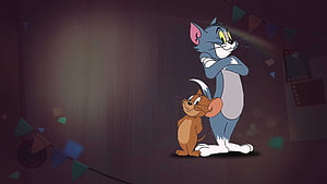 Tom and Jerry standing together in a dimly lit room with festive bunting decorations HD wallpaper