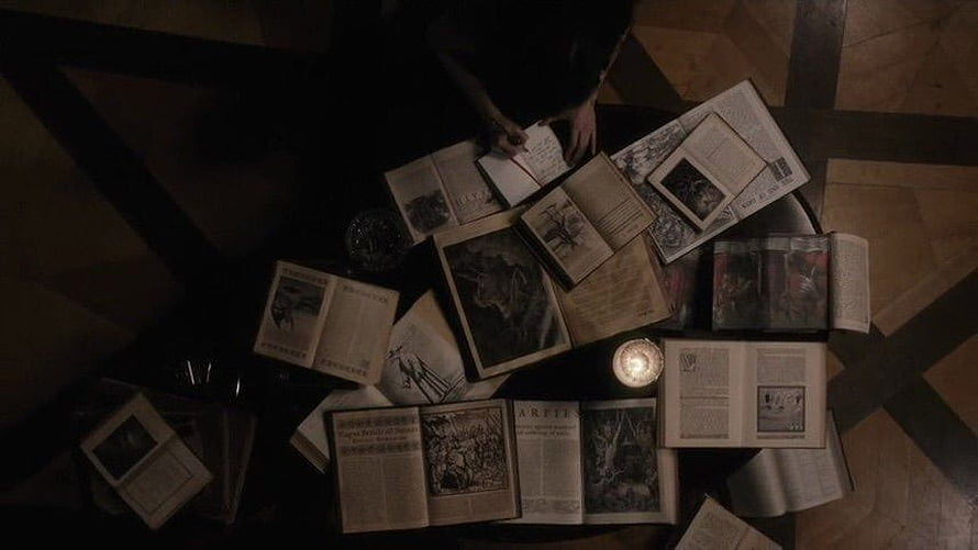 Dark Academia Aesthetic with Open Books and Candlelight on a Patterned Floor HD wallpaper