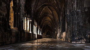 Gothic Stone Corridor with Arched Ceilings and Dramatic Sunlight HD wallpaper