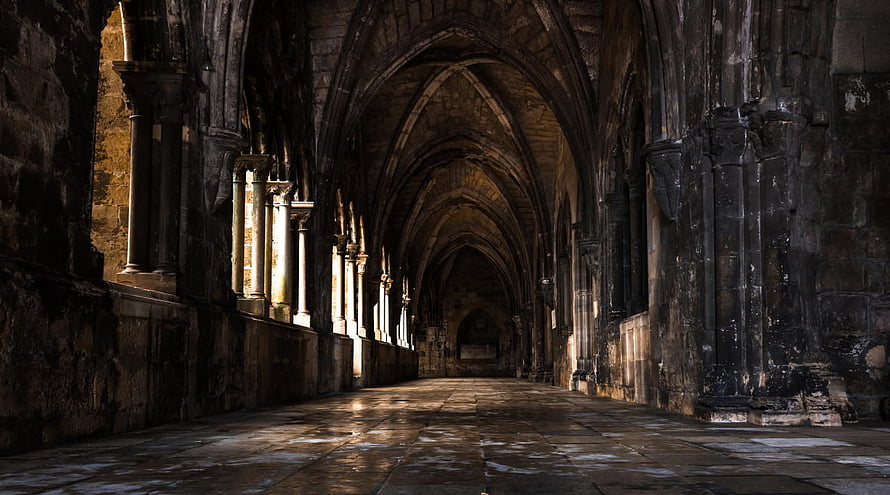 Gothic Stone Corridor with Arched Ceilings and Dramatic Sunlight HD wallpaper