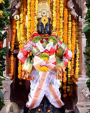 Lord Ayyappa Statue Adorned in Red and White Silk with Marigold Garlands HD phone wallpaper