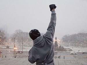 Rocky Balboa raising a glove in a snowy Philadelphia square HD wallpaper