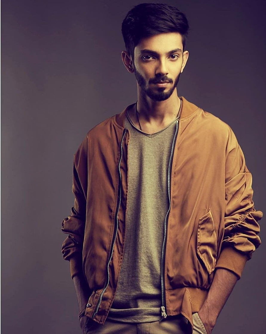 Anirudh Ravichander studio portrait in brown bomber jacket and grey t-shirt HD phone wallpaper