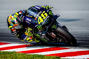 Valentino Rossi Cornering Yamaha YZR-M1 at High Speed on MotoGP Circuit HD wallpaper
