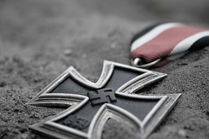 Close-up of Iron Cross Medal with Ribbon on Sandy Ground HD wallpaper