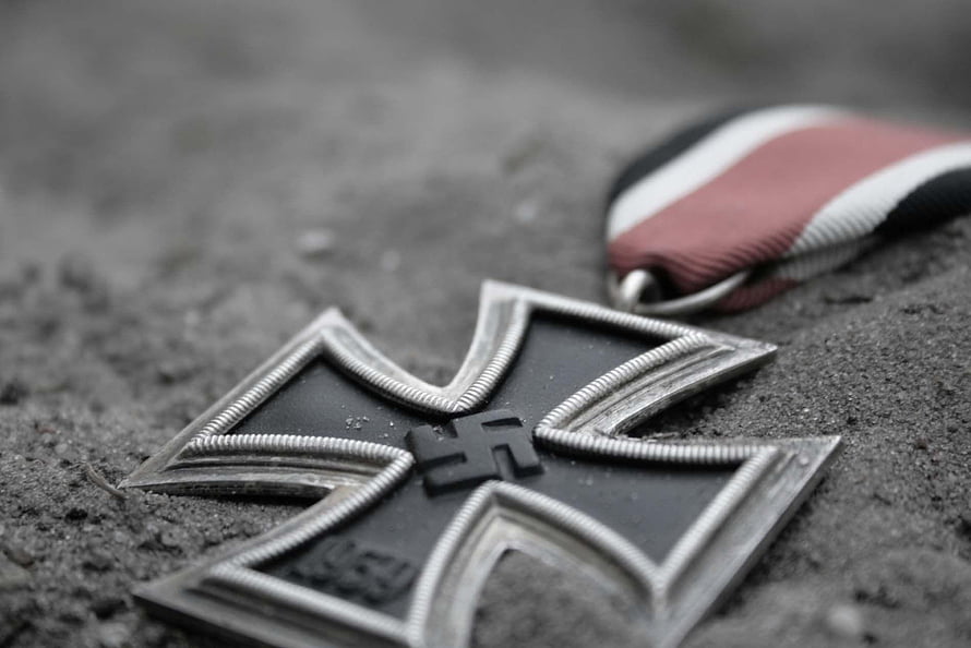 Close-up of Iron Cross Medal with Ribbon on Sandy Ground HD wallpaper