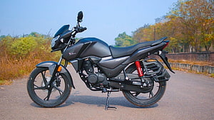 Black Honda SP 125 motorcycle parked on a paved road with red rear shock absorber HD wallpaper