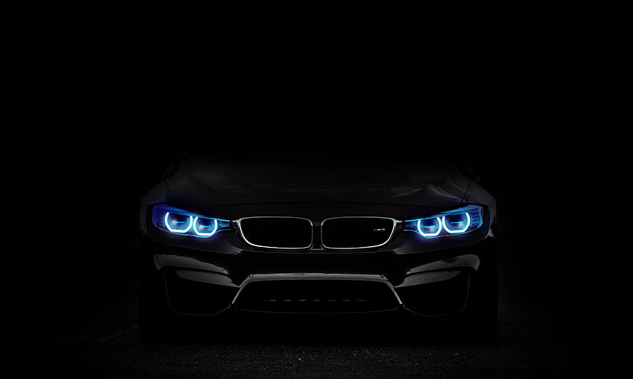 BMW M4 Front Fascia with Blue LED Headlights in Dark Studio Setting HD wallpaper