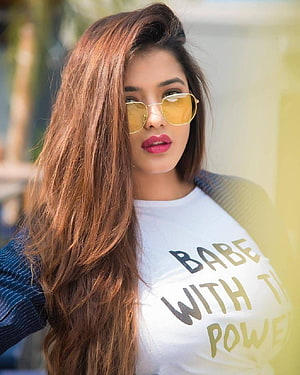 Woman with long brown hair wearing yellow sunglasses and a white graphic t-shirt posing outdoors, Ketika Sharma by Gurusad, #ketika sharma HD phone wallpaper
