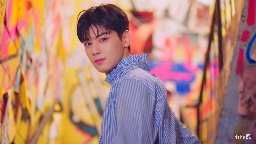 Cha Eun Woo in Blue Striped Shirt Against Vibrant Graffiti Wall HD wallpaper