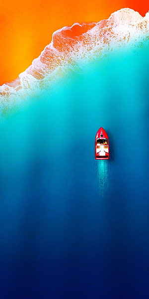 Vibrant Aerial View of Red Boat in Turquoise Ocean with Breaking Wave HD phone wallpaper