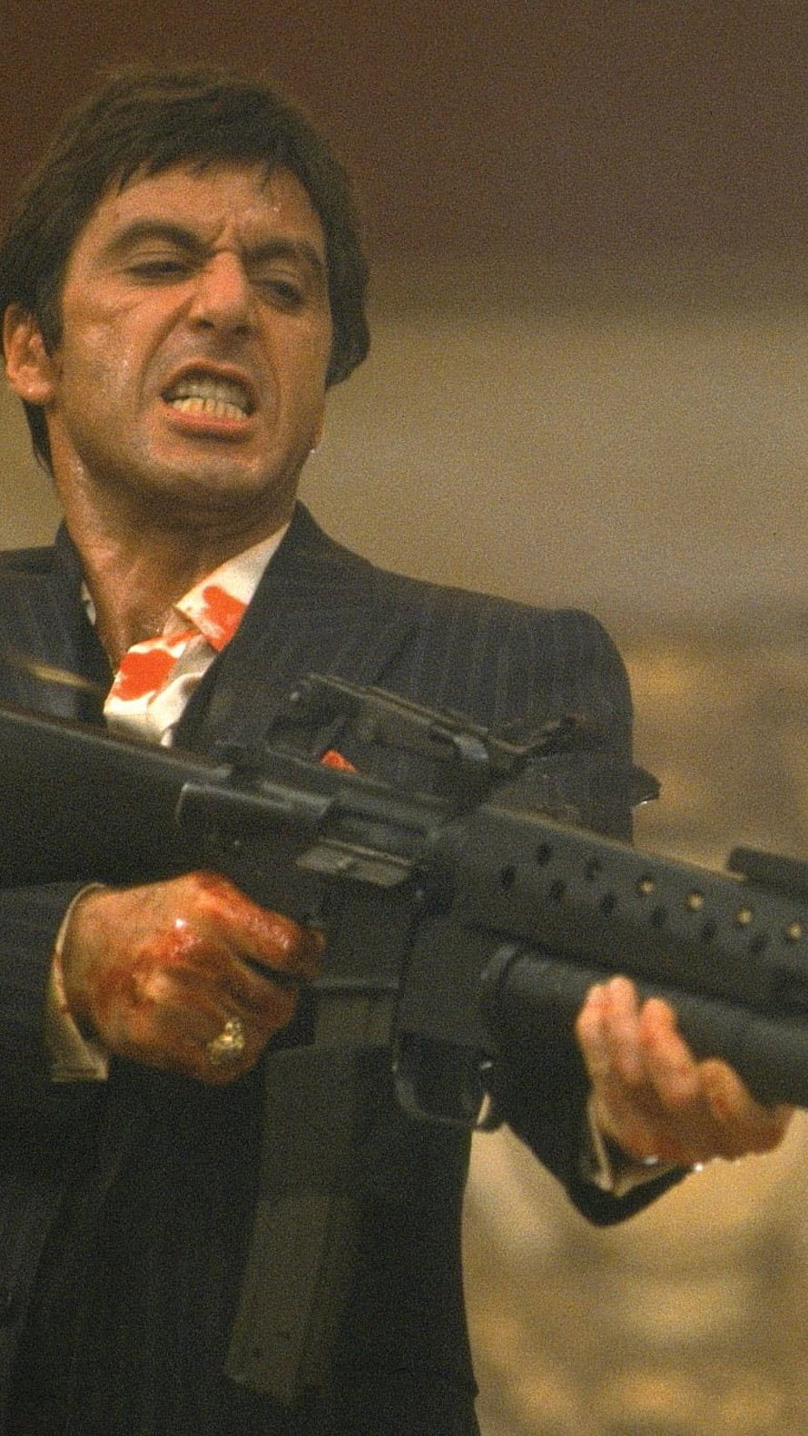 Al Pacino as Tony Montana in Scarface holding an assault rifle with blood on his hands and shirt HD phone wallpaper