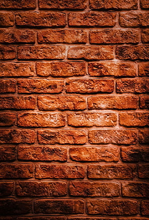 Vintage Red Brick Wall Texture Background With Warm Lighting And Rustic Charm HD phone wallpaper